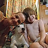 Ghost is registered to the contest to win money with this photo: woman, child, dog, indoor, smiling, blanket, curtains, wooden_wall, photograph, drawing, happy, portrait, family, together, casual, relaxed, home, light, hair, skin