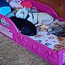 Ghost joined the competition — help win amazing prizes! dog, bed, pink, minnie_mouse, stuffed_animal, blanket, carpet, wood_wall, sleeping, pet, indoor, toy, childs_bed, animal, resting, black_dog, white_dog, fabric, cushion, cozy