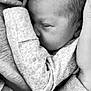 arm, baby, black_and_white, close_up, cuddle, face, hand, infant, intimacy, love, newborn, parent, patterned_clothing, peaceful, person, skin, sleeping, soft, texture, warmth
