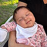 baby, infant, child, sleepy, smiling, portrait, outdoor, family, adult, arms, floral_outfit, bib, pink_clothing, blanket, grass, sunlight, patio, seated, close_up, happy