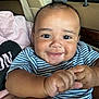 Adonis is registered to the contest to win money with this photo: baby, child, smile, face, hands, striped_shirt, car_seat, happy, portrait, infant, cute, person, young_child, skin, eyes, indoors, seatbelt, clothing, human, closeup