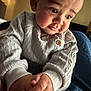 Adonis joined the competition — help win amazing prizes! baby, child, face, hands, sweater, knitwear, cute, indoors, portrait, skin, expression, chubby_cheeks, curious, warm_lighting, person, seated, infant, soft_texture, young, closeup