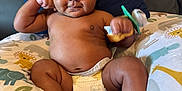 Adonis joined the competition — help win amazing prizes! baby, infant, diaper, couch, pillow, animal_print, pacifier, cute, chubby, smiling, indoor, child, skin, face, hand, foot, furniture, comfort, relaxing, playful