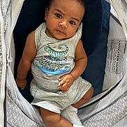 Adonis joined the competition — help win amazing prizes! baby, infant, child, dinosaur_print, grey_clothing, sneakers, anklet, seated, baby_seat, patterned_fabric, mesh, curious_expression, indoors, cute, portrait, small_hands, soft_toys, footwear, casual_outfit, comfortable