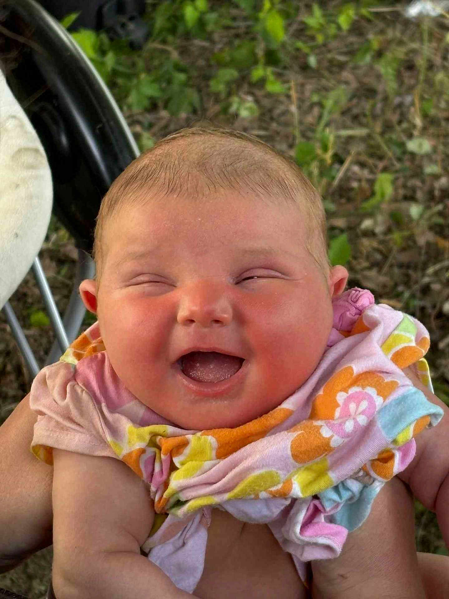 Nova joined the competition — help win amazing prizes! baby, infant, smiling, happy, cute, outdoor, blanket, colorful, person, face, skin, hand, nature, greenery, child, young, joy, expression, holding, portrait