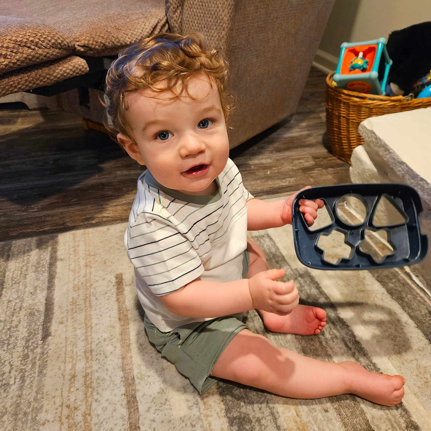 Silas is registered to the contest to win money with this photo: accessories, architecture, baby, building, clothing, couch, face, footwear, furniture, glasses, head, indoors, livingroom, person, photography, portrait, room, sandal, sitting, wood