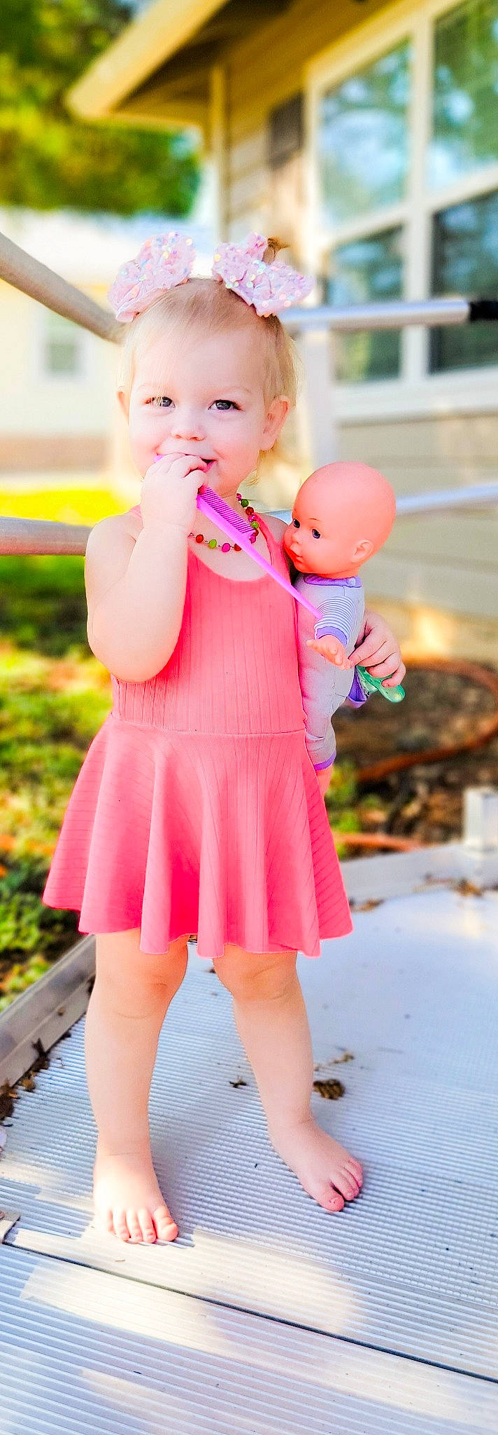 Gracelyn joined the competition — help win amazing prizes! baby, baby_toddler_clothing, dress, face, finger, fun, gesture, grass, happy, head, interaction, joy, orange, people_in_nature, person, photograph, pink, skin, smile, standing