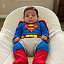 baby, baby_clothing, blue_outfit, child, costume, cute, furniture, home, indoor, infant, natural_light, person, portrait, red_booties, seated, soft_texture, superhero, superman_costume, white_chair, window