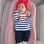 Maïlyne a rejoint le concours — aidez-le/la à gagner de superbes lots ! baby, infant, headband, red_bow, striped_shirt, blue_stripes, white_stripes, black_pants, white_shoes, pink_cushion, soft_fabric, indoor, crib, cute, portrait, child, fist, looking, resting, comfortable