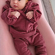 Maïlyne participe au concours pour gagner de l'argent avec cette photo : baby, infant, clothing, pajamas, pink, maroon, face, hand, footwear, booties, soft, cushion, indoor, portrait, newborn, cute, child, person, comfortable, resting