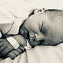 baby, newborn, sleeping, blanket, monochrome, hospital_band, hand, face, infant, peaceful, soft_light, portrait, closeup, skin, child, resting, head, quiet, toddler, bed