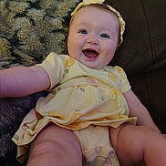 Azelea joined the competition — help win amazing prizes! baby, blanket, child, chubby_legs, couch, cute, expression, face, happy, headband, indoor, infant, person, photography, portrait, sitting, skin, smiling, yellow_dress, young