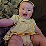 baby, blanket, child, chubby_legs, couch, cute, expression, face, happy, headband, indoor, infant, person, photography, portrait, sitting, skin, smiling, yellow_dress, young