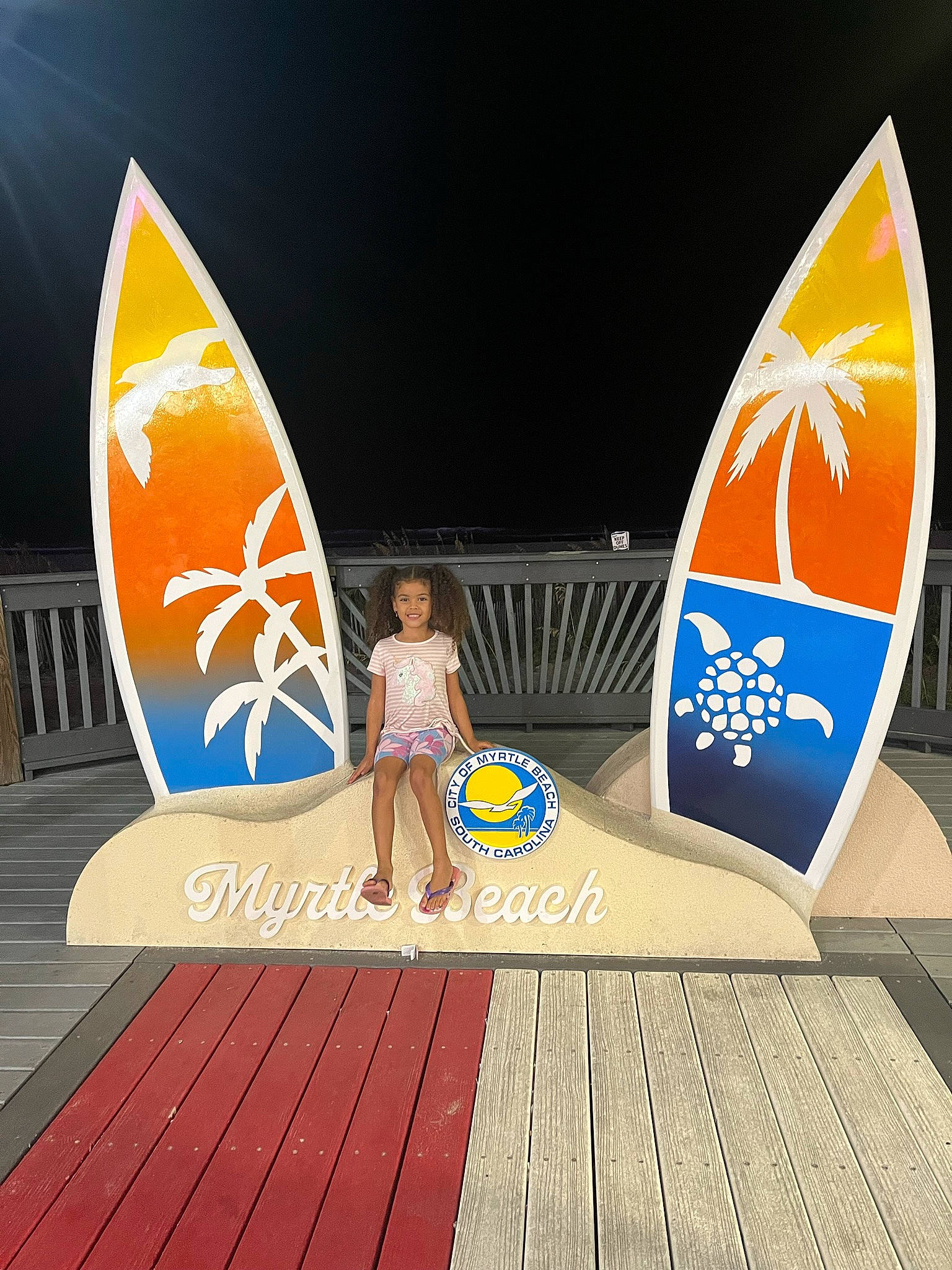 Bianca is registered to the contest to win money with this photo: composite_material, fun, graphics, human_leg, joy, leisure, person, recreation, sports, surface_water_sports, surfboard, surfing_equipment, thigh, triangle, wind, wood, world