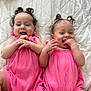 Anahi And Areli is registered to the contest to win money with this photo: baby, infant, twin, pink_clothing, curly_hair, pigtails, smiling, laughing, hands, bed, blanket, quilted, cute, happy, lying_down, child, indoors, playful, two_people, person
