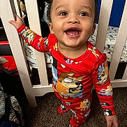 Dashine joined the competition — help win amazing prizes! toddler, child, pajamas, red_clothing, smiling, baby, crib, nursery, carpet, bed, furniture, indoor, person, happy, standing, hand, face, cute, cartoon_print, closeup
