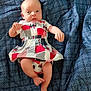 Brilynn joined the competition — help win amazing prizes! baby, infant, dress, patterned_clothing, blue_blanket, lying_down, small_hands, bare_legs, foot, face, curious_expression, newborn, soft_fabric, indoors, child, cute, portrait, skin, head, person