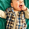 Mateo joined the competition — help win amazing prizes! baby, beige_shirt, buttoned_shirt, child, clothing, cute, expressive, face, hand_in_mouth, happy, infant, lying_down, plaid_shirt, portrait, short_hair, skin, smiling, teal_background, toddler, young_child