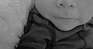 Mateo is registered to the contest to win money with this photo: baby, infant, close_up, black_and_white, face, eyes, soft_blanket, striped_clothing, portrait, cute, child, newborn, laying_down, expression, skin, small_person, young, monochrome, baby_clothes, cozy