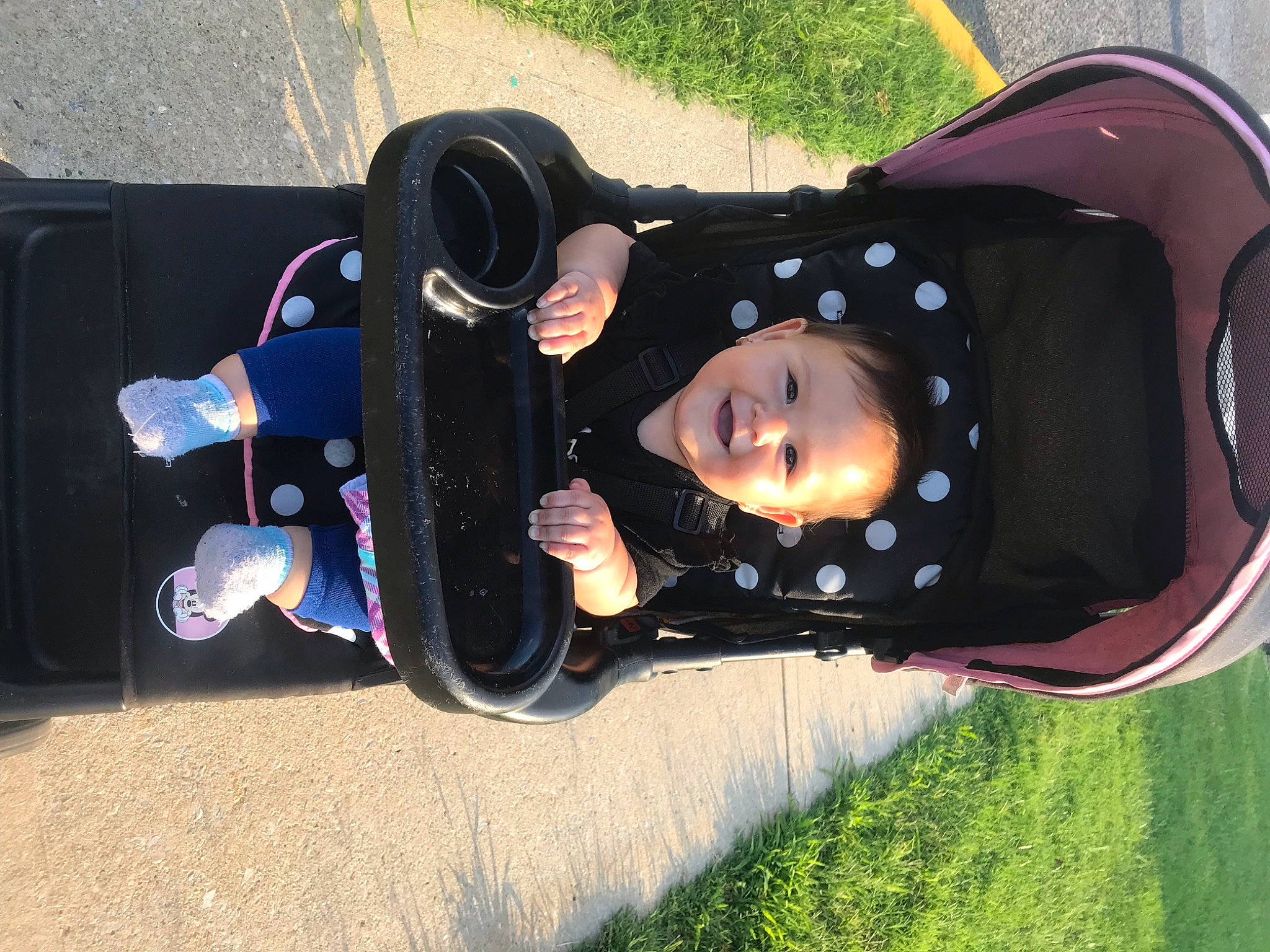 Martha is registered to the contest to win money with this photo: auto_part, automotive_exterior, baby_carriage, baby_products, carmine, child, costume, fashion_accessory, fun, grass, joy, leisure, person, personal_protective_equipment, plant, recreation, toddler, tree