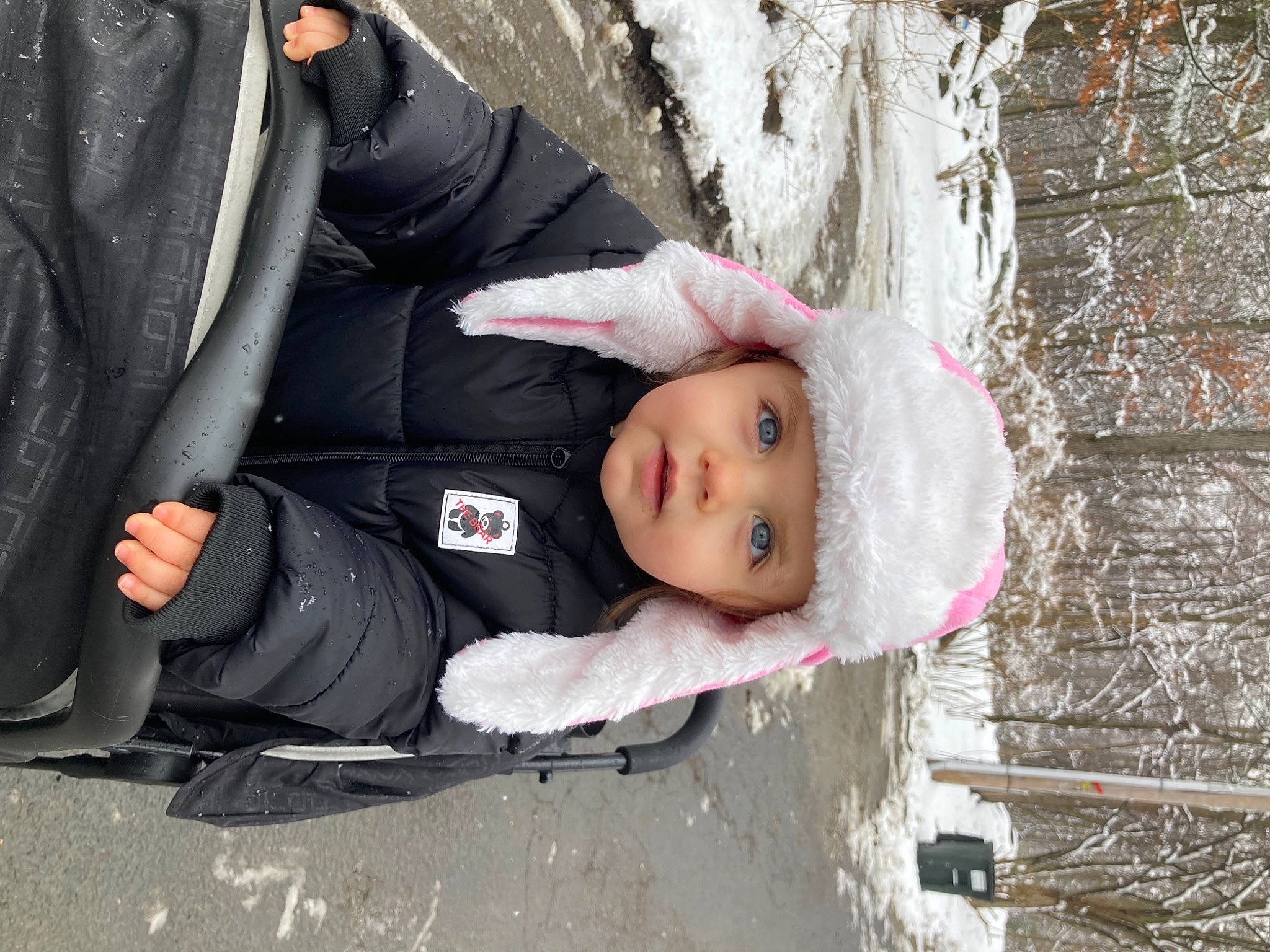 Julianna joined the competition — help win amazing prizes! baby, baby_toddler_clothing, cheek, child, comfort, eye, freezing, fur, grass, headwear, human_body, person, plant, sitting, snow, toddler, tree, winter, wood