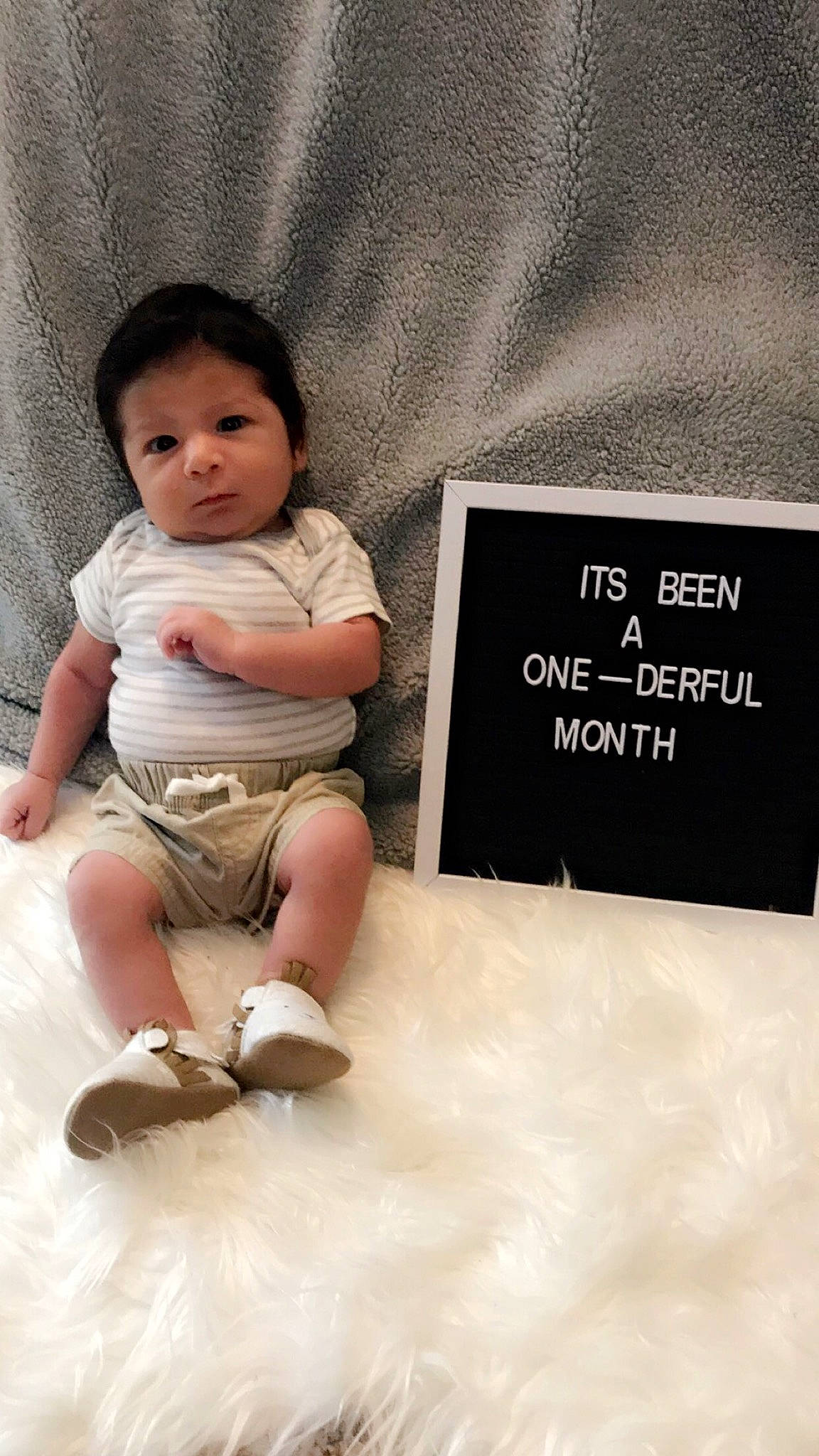 Attikus is registered to the contest to win money with this photo: baby, baby_toddler_clothing, cheek, child, happy, head, human, leg, person, product, shoe, sitting, skin, smile, toddler