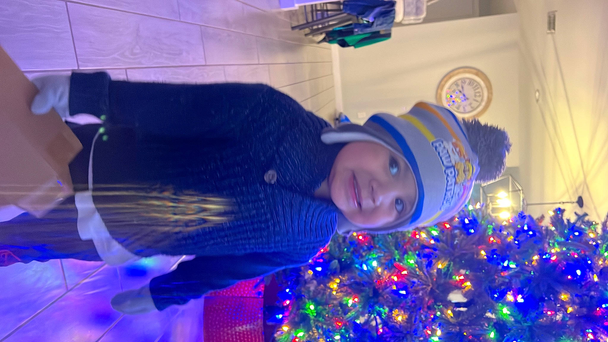 Elias is registered to the contest to win money with this photo: blue, christmas_decoration, christmas_eve, christmas_ornament, christmas_tree, electric_blue, event, fun, happy, hat, headwear, holiday, holiday_ornament, joy, magenta, ornament, person, plant, purple, smile