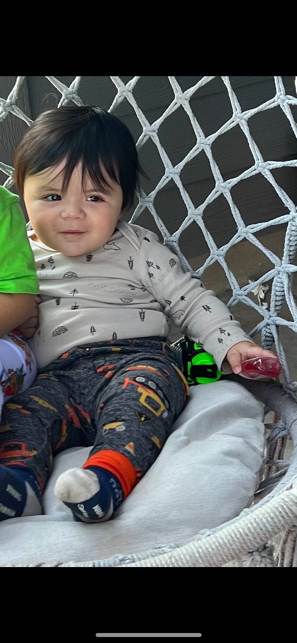 Diego joined the competition — help win amazing prizes! arm, baby_toddler_clothing, cool, fence, grass, happy, human_body, human_leg, knee, leg, mammal, mesh, pattern, person, sitting, sleeve, sock, thigh, toddler, vertebrate