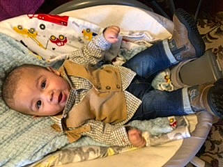 Jesus is registered to the contest to win money with this photo: baby, baby_products, baby_toddler_clothing, baby_toys, bedtime, cheek, child, comfort, flooring, fun, infant_bed, linens, nap, person, product, room, sleep, toddler, wood