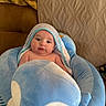 baby, blanket, blue, couch, cute, face, furniture, hood, indoors, infant, pattern, person, plush, portrait, seat, striped, toddler, toy, warm, wrapped