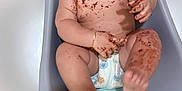Jordan is registered to the contest to win money with this photo: baby, bracelet, child, chocolate, cute, diaper, face, floor, foot, fun, hand, happy, infant, messy, mouth, sitting, skin, smiling, tile, tub