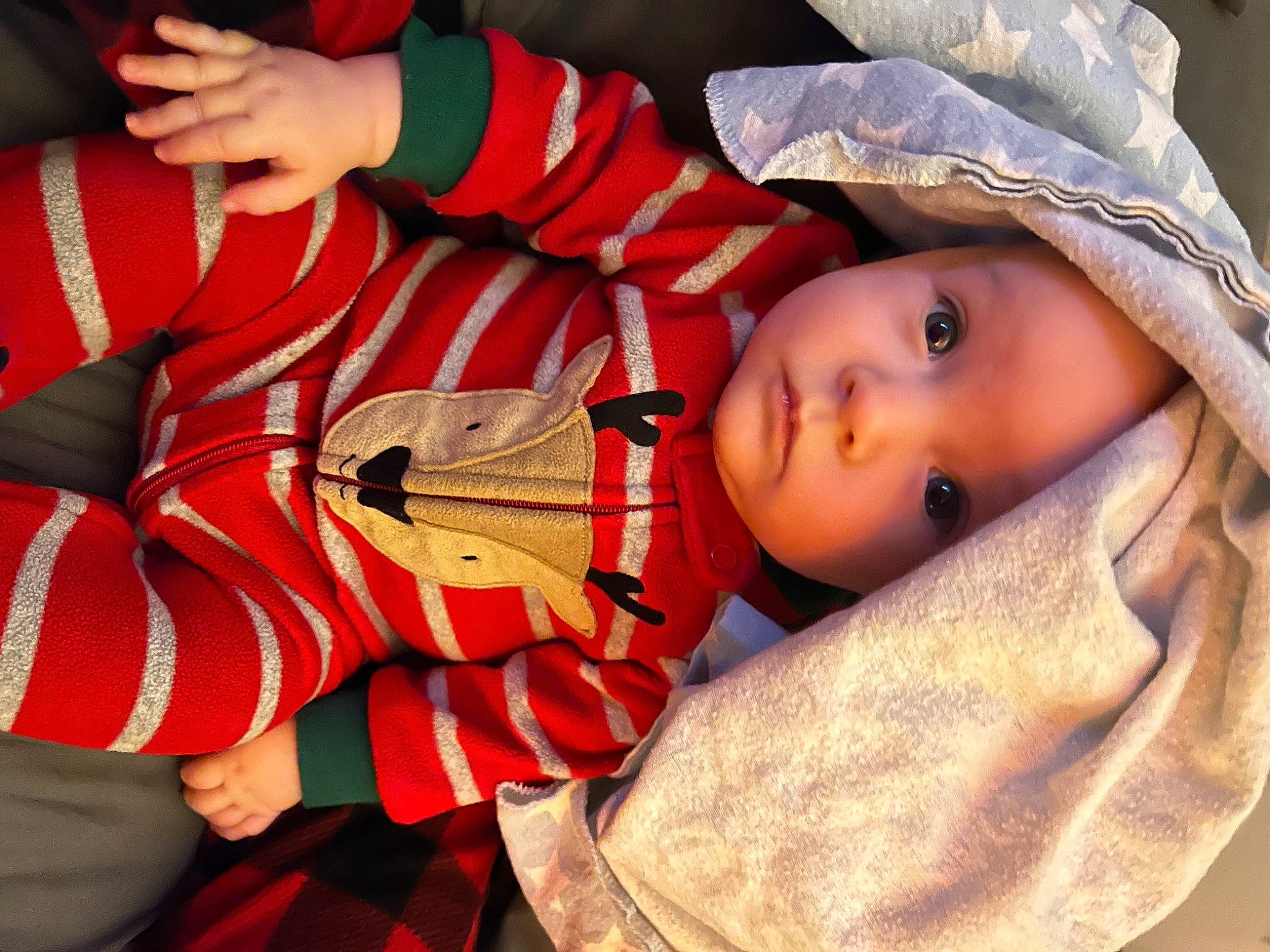 London is registered to the contest to win money with this photo: baby, baby_products, child, eyelash, fun, fur, hand, happy, hat, headwear, human_body, mouth, nose, orange, pattern, person, portrait_photography, sitting, skin, toddler