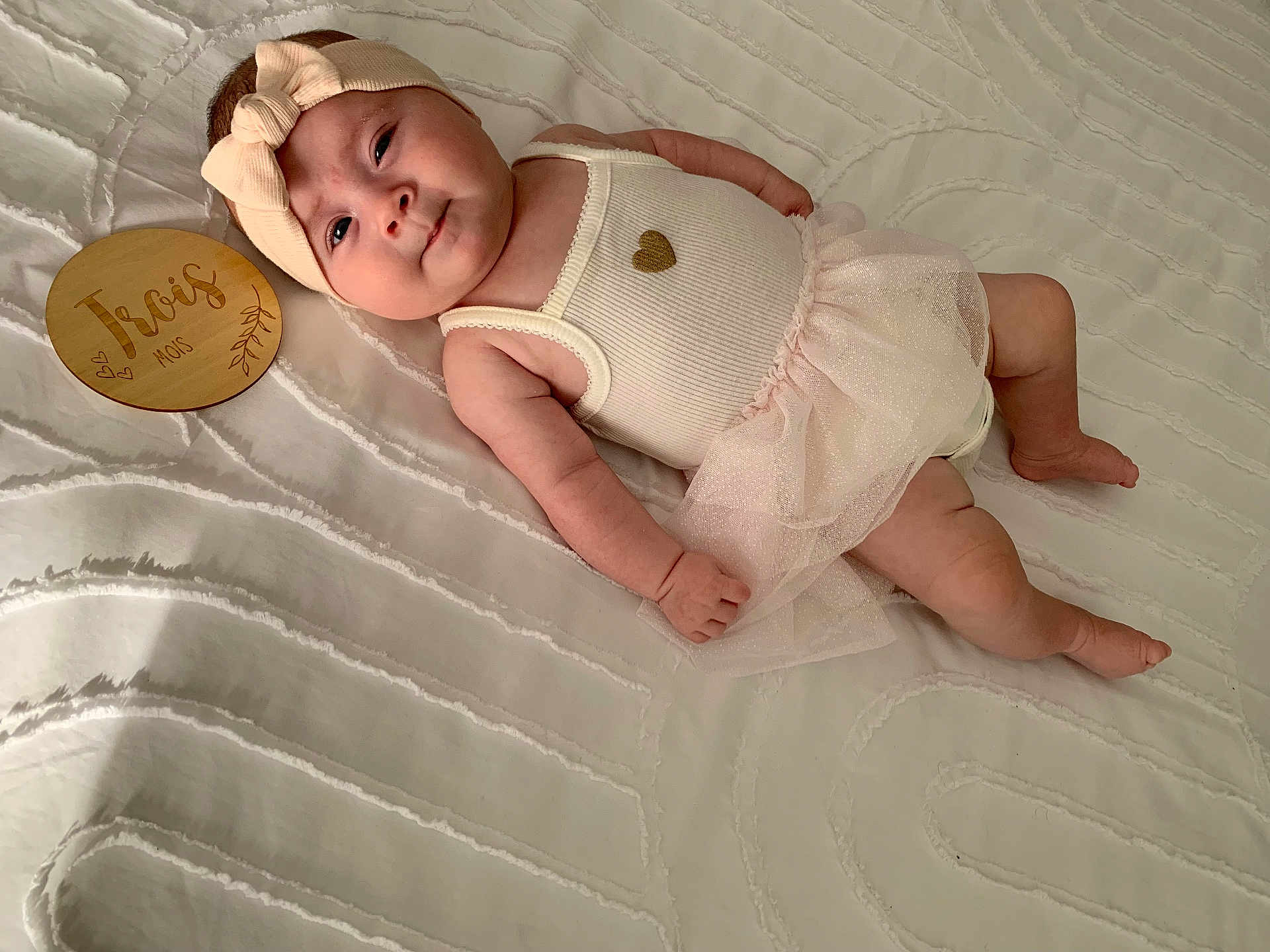 Jade participe au concours pour gagner de l'argent avec cette photo : baby, infant, headband, tutu, pink, white, blanket, wooden_plaque, lying_down, cute, child, soft_texture, clothing, portrait, indoors, newborn, skin, face, hand, foot