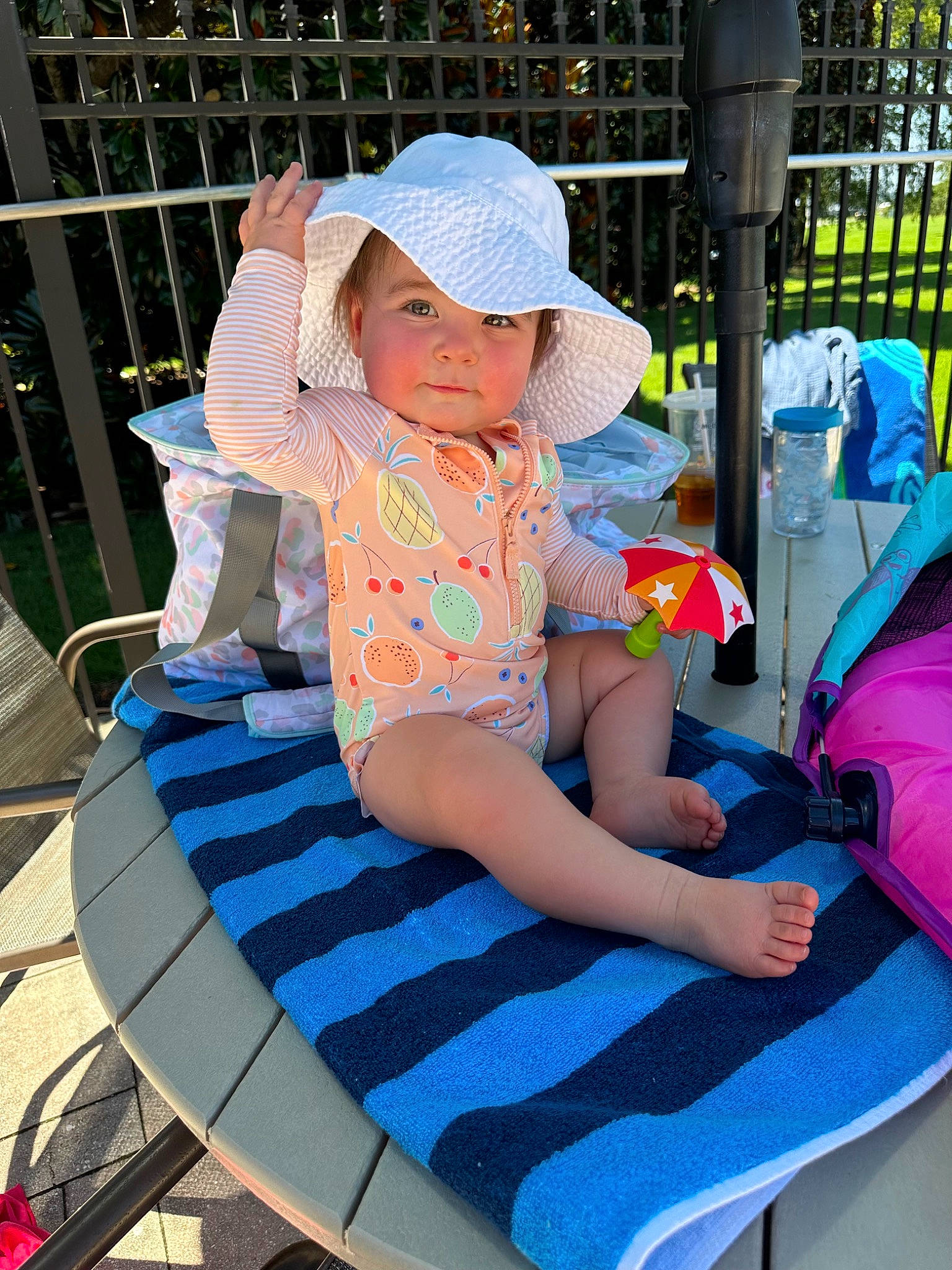 Sydney joined the competition — help win amazing prizes! baby_products, baby_toddler_clothing, baseball_cap, cap, child, comfort, electric_blue, fence, fun, hat, headwear, human_leg, lap, leisure, outdoor_furniture, person, public_space, recreation, sandal, sitting