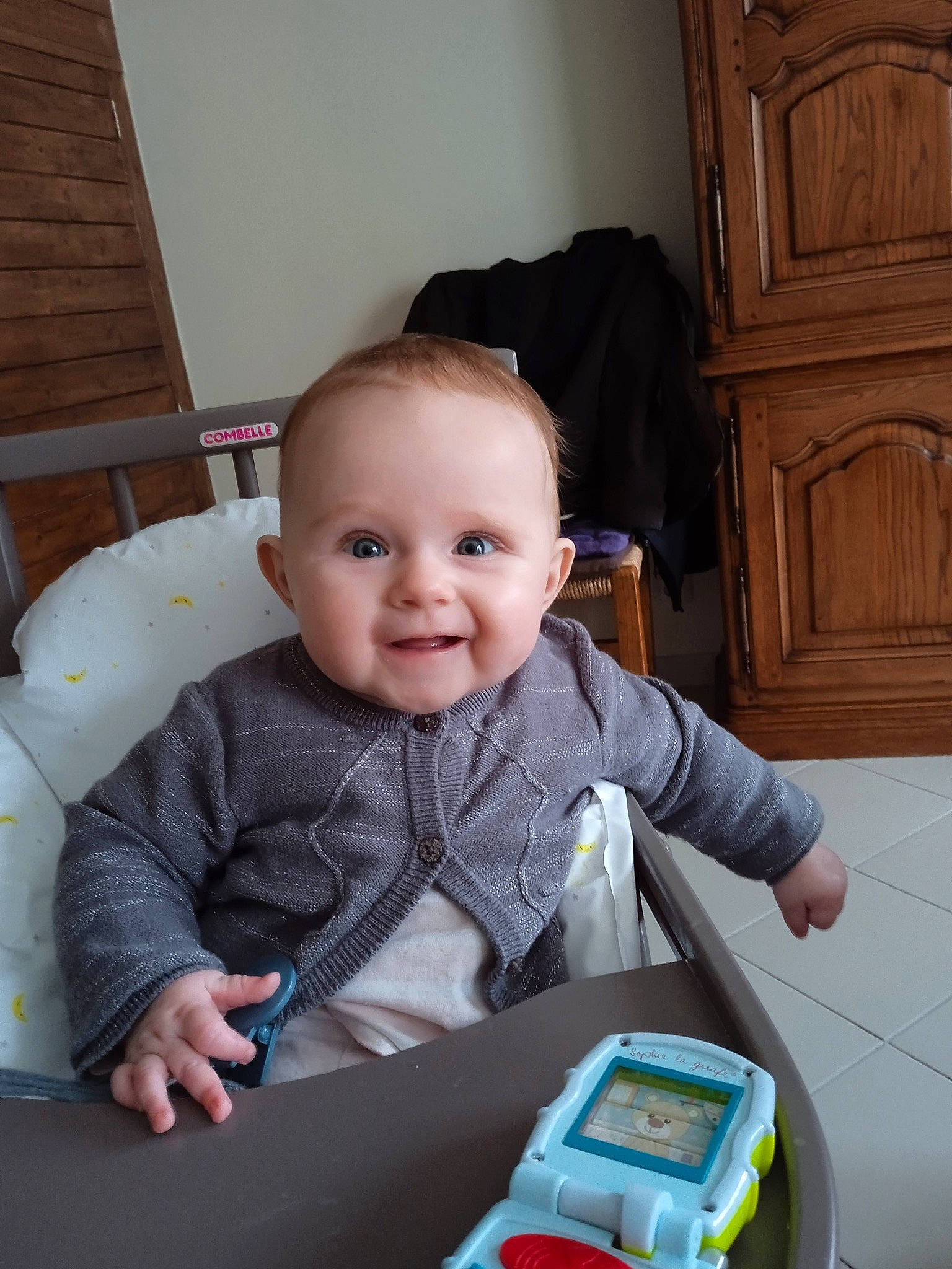 Lanaë a rejoint le concours — aidez-le/la à gagner de superbes lots ! baby, baby_playing_with_toys, baby_products, baby_toddler_clothing, baby_toys, cabinetry, cheek, child, comfort, flooring, fun, happy, iris, joy, person, room, sitting, skin, smile, toddler