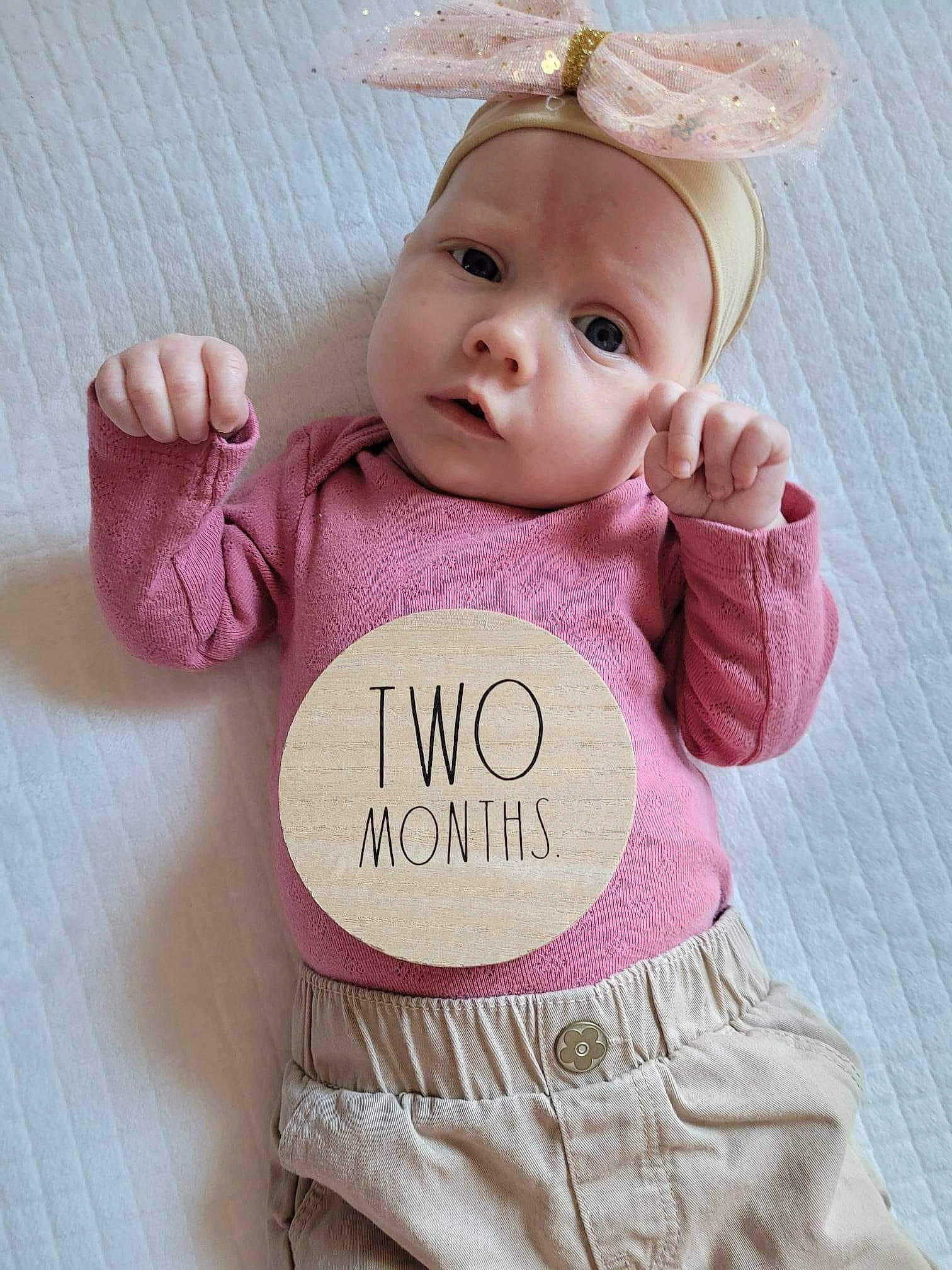 Gracelynn is registered to the contest to win money with this photo: baby, baby_products, baby_toddler_clothing, child, doll, dress, eyelash, fashion_accessory, finger, font, hand, happy, magenta, pattern, person, pink, skin, sleeve, toy, white