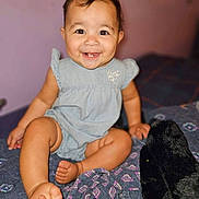 Jocelyn is registered to the contest to win money with this photo: baby, babylaughing, bed, bedroom, clothing, cushion, dress, face, furniture, happy, head, indoors, laughing, pants, person, photography, portrait, room, sitting, smile