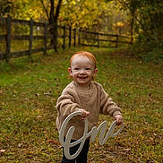 Sophia joined the competition — help win amazing prizes! autumn, birthday, celebration, child, cute, fence, grass, happy, leaves, nature, outdoor, path, person, portrait, red_hair, sign, smiling, sweater, toddler, young