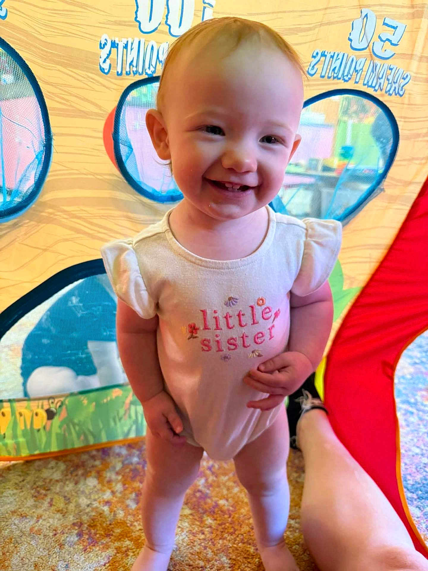 Sophia joined the competition — help win amazing prizes! toddler, child, smiling, indoor, play_tent, onesie, little_sister, happy, standing, carpet, colorful, cute, baby, person, portrait, feet, playtime, fun, bright, casual