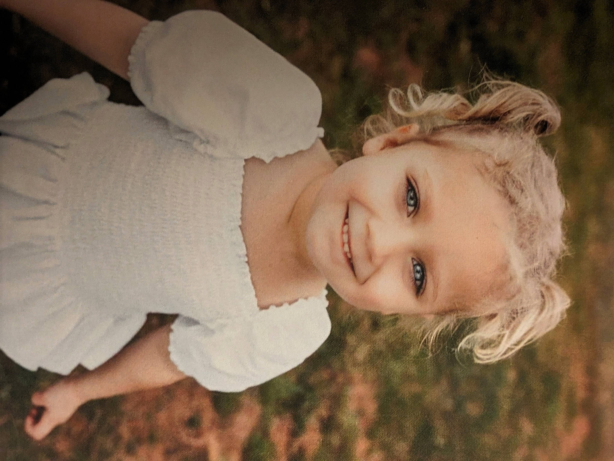 Shayla is registered to the contest to win money with this photo: blond, brown_hair, dress, eye, face, flash_photography, gesture, grass, hair, happy, iris, joy, lip, nose, people_in_nature, person, plant, skin, sky, smile