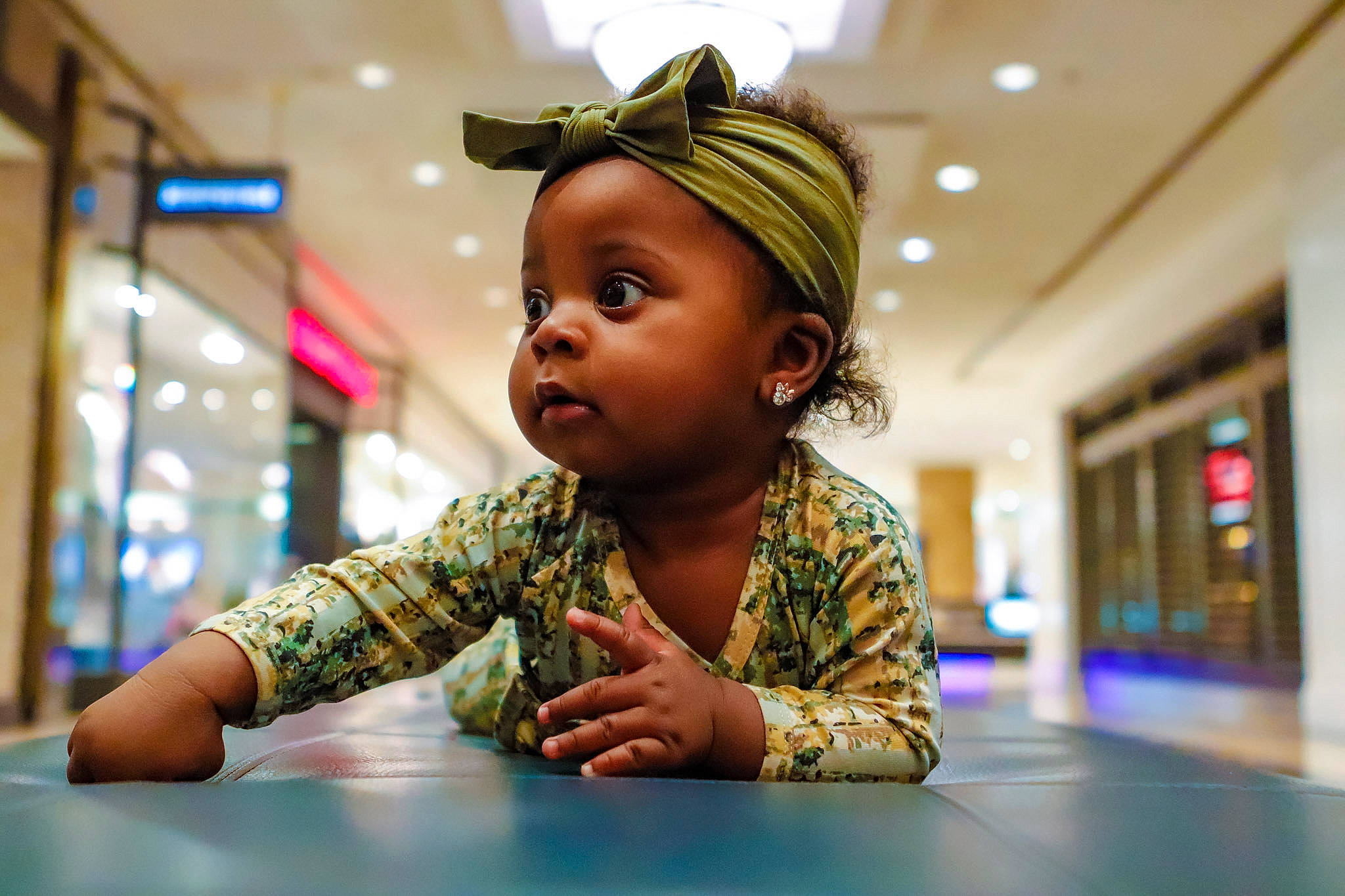 Ava-marie is registered to the contest to win money with this photo: baby, child, desk, event, fashion_accessory, floor, flooring, fun, happy, leisure, person, portrait_photography, recreation, room, sitting, table, toddler, vacation, wood