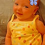baby, child, smiling, yellow_clothing, polka_dot, butterflies, indoor, cute, happy, infant, portrait, sitting, playful, soft_light, closeup, face, cheerful, young_child, fun, colorful