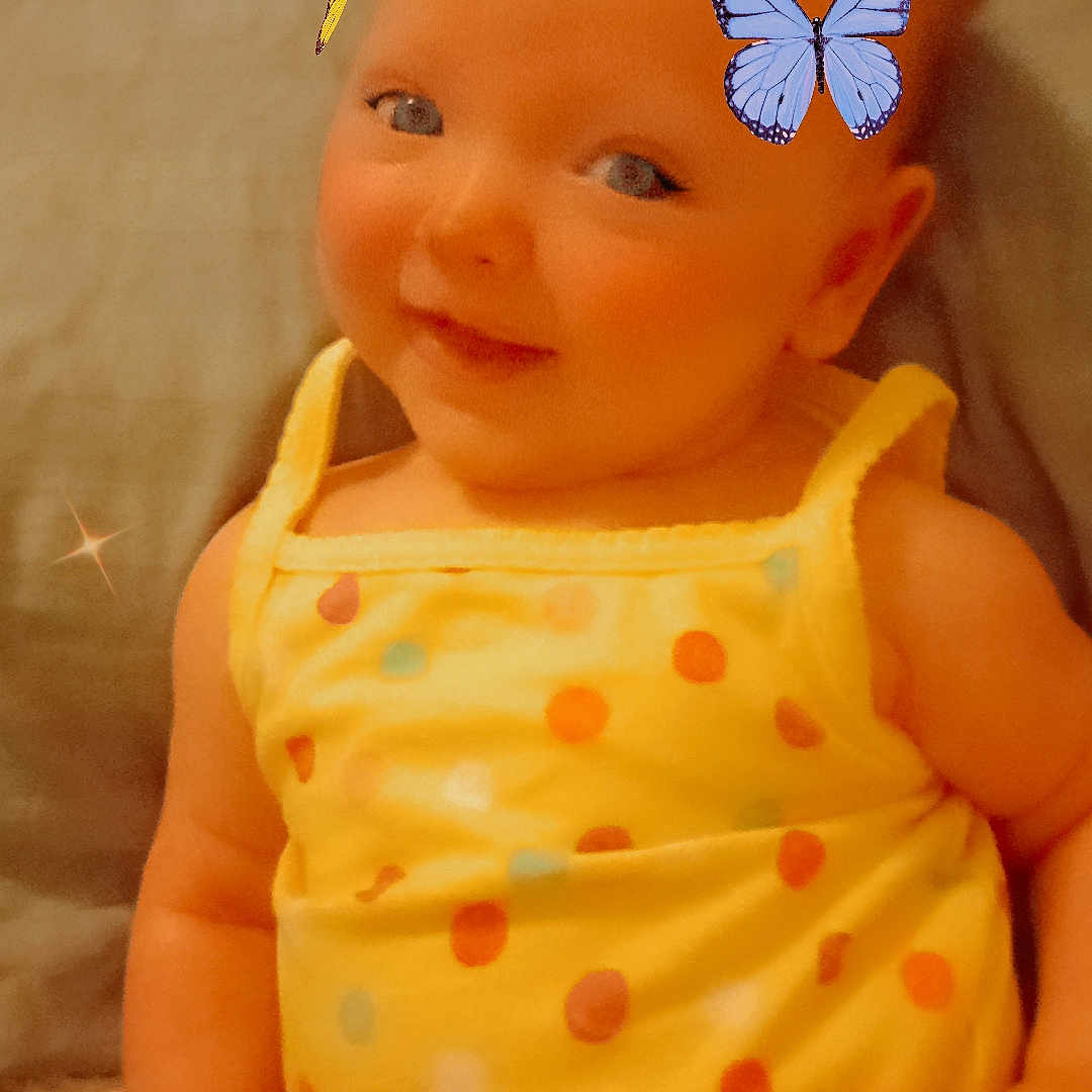 Meadow Azalea is registered to the contest to win money with this photo: baby, butterflies, cheerful, child, closeup, colorful, cute, face, fun, happy, indoor, infant, playful, polka_dot, portrait, sitting, smiling, soft_light, yellow_clothing, young_child