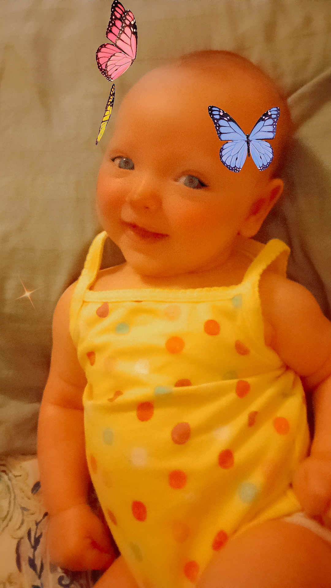 Meadow Azalea is registered to the contest to win money with this photo: baby, child, smiling, yellow_clothing, polka_dot, butterflies, indoor, cute, happy, infant, portrait, sitting, playful, soft_light, closeup, face, cheerful, young_child, fun, colorful