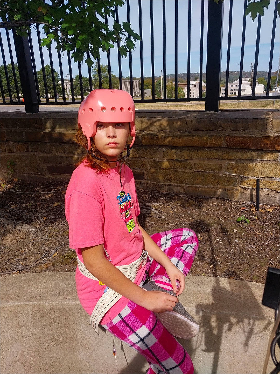 Sarah is registered to the contest to win money with this photo: bicycle_helmet, bicycles_equipment_and_supplies, cap, child, eyewear, fashion_accessory, fun, happy, headwear, helmet, leisure, magenta, person, personal_protective_equipment, pink, plaid, recreation, sitting, summer, tartan