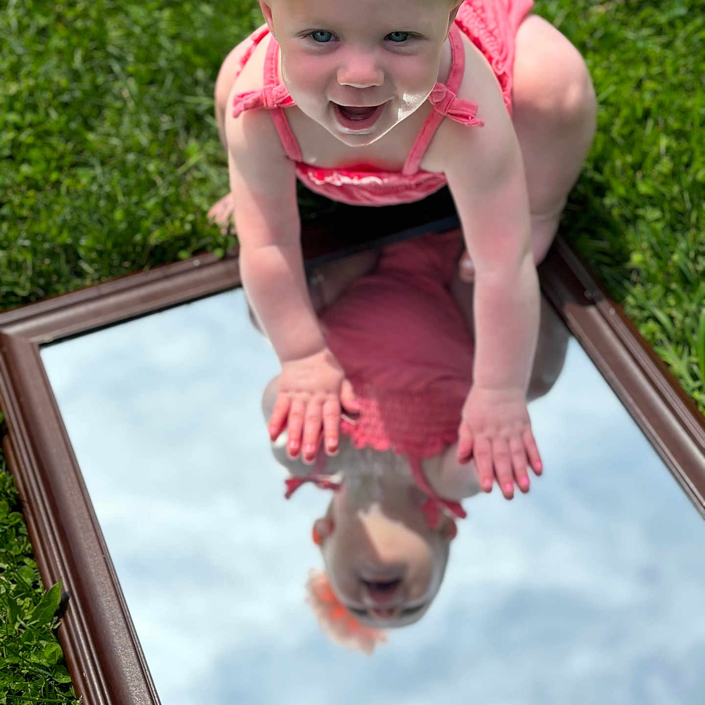 Emberly is registered to the contest to win money with this photo: accessories, baby, bodypart, clothing, dress, face, finger, grass, hand, hat, head, lawn, outdoors, person, photography, plant, pool, portrait, summer, water