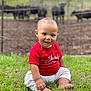 Kayden joined the competition — help win amazing prizes! baby, child, grass, outdoor, smiling, red_shirt, white_pants, barefoot, cows, fence, nature, greenery, portrait, sitting, happy, cute, young, animal, farm, daylight