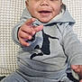 Kayden joined the competition — help win amazing prizes! baby, child, smiling, happy, hoodie, sweatpants, grey_clothing, sitting, indoor, cushion, fabric, person, portrait, cute, small_child, infant, reaching_hand, face, head, cozy