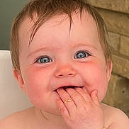 Delilah is registered to the contest to win money with this photo: baby, child, face, hand, fingers, blue_eyes, smile, messy_hair, skin, indoor, highchair, food, happy, cute, portrait, infant, expression, closeup, chubby_cheeks, natural_light