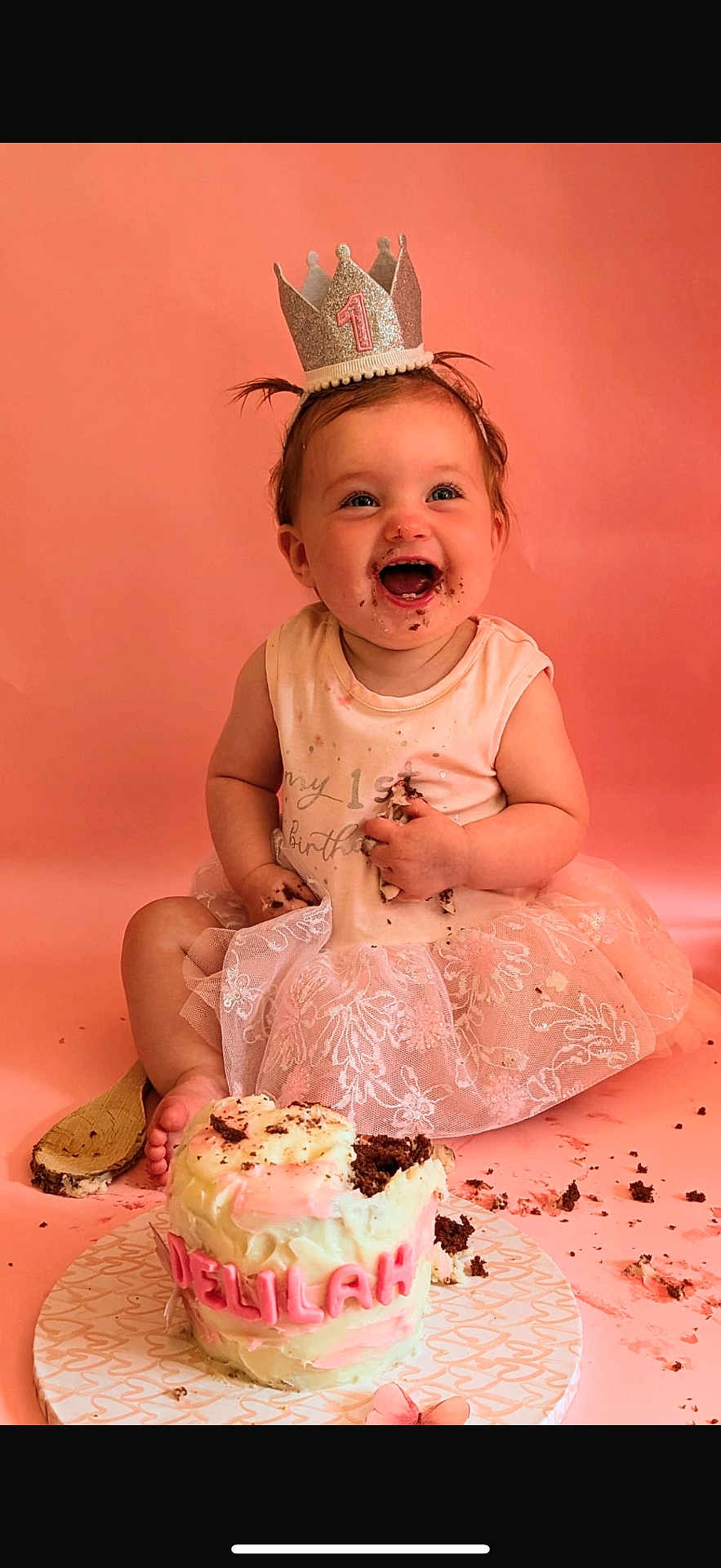 Delilah joined the competition — help win amazing prizes! baby, birthday, cake, crown, pink, smiling, happy, messy, face_paint, celebration, tutu, sitting, child, first_birthday, cream, frosting, party, cute, fun, portrait